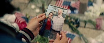 Movie still from “Gen V” (2023), created by Eric Kripke – A person holding a picture of a man and a woman; Close Up shot, Overhead angle