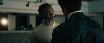 Movie still from “Gen V” (2023), created by Eric Kripke – A man with a beard talking to another man in a suit; Close Up shot, Over the shoulder angle