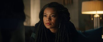 Movie still from “Gen V” (2023), created by Eric Kripke – A person with dreadlocks looking at the camera; Close Up shot, Over the shoulder angle