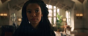 Movie still from “Gen V” (2023), created by Eric Kripke – A person with dreads looking at the camera; Close Up shot, Low angle