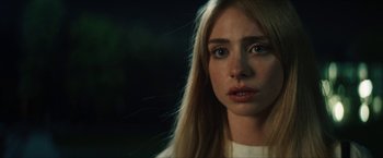 Movie still from “Gen V” (2023), created by Eric Kripke – A person with long blonde hair; Close Up shot, Over the shoulder angle