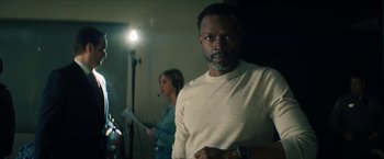 Movie still from “Gen V” (2023), created by Eric Kripke – A man and a woman are standing in front of a microphone; Medium shot, Over the shoulder angle