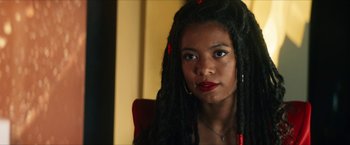 Movie still from “Gen V” (2023), created by Eric Kripke – A woman with dreadlocks sitting in front of a mirror; Close Up shot, Over the shoulder angle