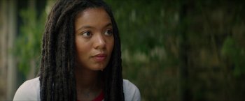 Movie still from “Gen V” (2023), created by Eric Kripke – A woman with dreads looking to her left; Close Up shot, Low angle