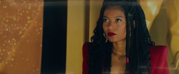 Movie still from “Gen V” (2023), created by Eric Kripke – A woman with red lipstick looking out a window; Close Up shot, Low angle