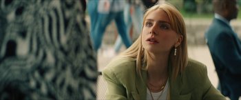 Movie still from “Gen V” (2023), created by Eric Kripke – A woman with blonde hair and a green jacket looking off into the distance; Close Up shot, Over the shoulder angle