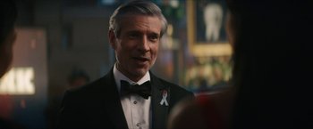 Movie still from “Gen V” (2023), created by Eric Kripke – A person wearing a suit and tie; Close Up shot, Over the shoulder angle