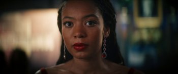 Movie still from “Gen V” (2023), created by Eric Kripke – A person wearing a necklace and earrings; Close Up shot, Low angle