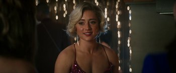 Movie still from “Gen V” (2023), created by Eric Kripke – A beautiful blonde woman in a pink dress; Close Up shot, Over the shoulder angle