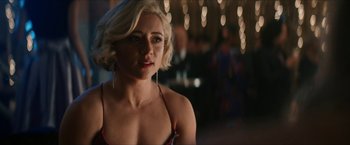 Movie still from “Gen V” (2023), created by Eric Kripke – A woman with blonde hair is posing for a picture; Close Up shot, Over the shoulder angle