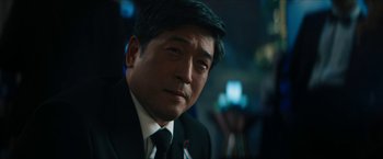 Movie still from “Gen V” (2023), created by Eric Kripke – A person wearing a suit and tie; Close Up shot, Over the shoulder angle