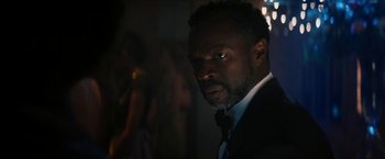 Movie still from “Gen V” (2023), created by Eric Kripke – A man wearing a suit and bow tie; Close Up shot, Over the shoulder angle