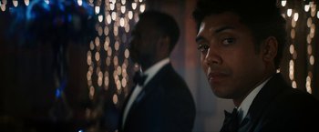 Movie still from “Gen V” (2023), created by Eric Kripke – A man in a suit standing next to another man in a suit; Close Up shot, Low angle