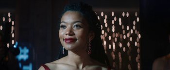 Movie still from “Gen V” (2023), created by Eric Kripke – A woman with long black hair wearing red earrings; Close Up shot, Low angle