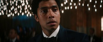 Movie still from “Gen V” (2023), created by Eric Kripke – A person wearing a suit and bow tie; Close Up shot, Low angle