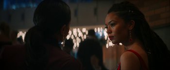 Movie still from “Gen V” (2023), created by Eric Kripke – A woman is looking at another woman in front of lights; Close Up shot, Over the shoulder angle