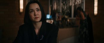 Movie still from “Gen V” (2023), created by Eric Kripke – A woman in a black jacket sitting in front of a window; Close Up shot, Over the shoulder angle