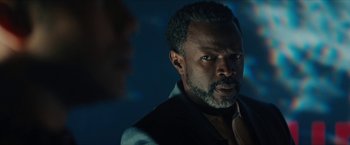 Movie still from “Gen V” (2023), created by Eric Kripke – A man with a beard is looking at the camera; Close Up shot, Over the shoulder angle