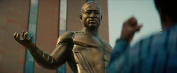 Movie still from “Gen V” (2023), created by Eric Kripke – A statue of a man in a suit; Extreme Close Up shot, Low angle