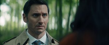 Movie still from “Gen V” (2023), created by Eric Kripke – A person wearing a suit and tie; Close Up shot, Over the shoulder angle