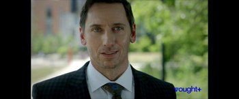 Movie still from “Gen V” (2023), created by Eric Kripke – A person wearing a suit and tie; Close Up shot, Over the shoulder angle