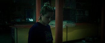 Movie still from “Gen V” (2023), created by Eric Kripke – A woman in a dark room looking down at the floor; Close Up shot, Over the shoulder angle