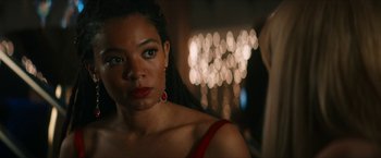 Movie still from “Gen V” (2023), created by Eric Kripke – A woman in a red dress and a red earring; Close Up shot, Over the shoulder angle
