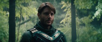 Movie still from “Gen V” (2023), created by Eric Kripke – A person wearing a costume near trees; Close Up shot, Over the shoulder angle