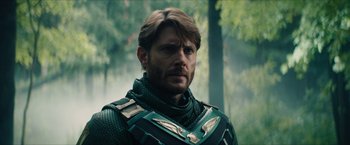 Movie still from “Gen V” (2023), created by Eric Kripke – A person wearing a suit of armor; Close Up shot, Over the shoulder angle