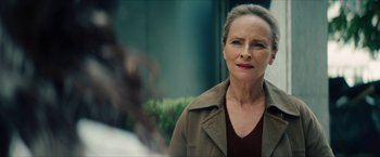 Movie still from “Gen V” (2023), created by Eric Kripke – An older woman in a brown jacket looking at the camera; Close Up shot, Over the shoulder angle