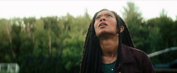 Movie still from “Gen V” (2023), created by Eric Kripke – A person with dreads looking up at the sky; Close Up shot, Low angle