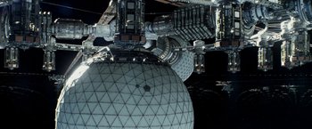 Movie still from “Geostorm” (2017), directed by Dean Devlin – A view of a building from the space station; Extreme Wide shot, Overhead angle