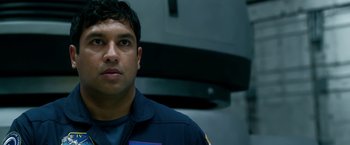 Movie still from “Geostorm” (2017), directed by Dean Devlin – A person wearing a blue uniform; Close Up shot, Low angle