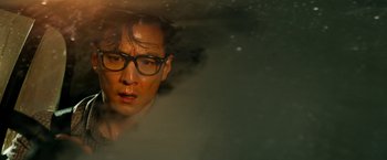 Movie still from “Geostorm” (2017), directed by Dean Devlin – A person wearing glasses in the water; Close Up shot, High angle