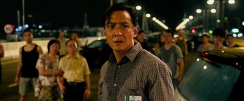 Movie still from “Geostorm” (2017), directed by Dean Devlin – A man in a checkered shirt is looking at the camera; Close Up shot, Over the shoulder angle