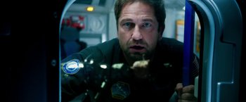 Movie still from “Geostorm” (2017), directed by Dean Devlin – A person looking out of a window; Close Up shot, Over the shoulder angle