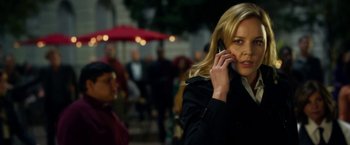 Movie still from “Geostorm” (2017), directed by Dean Devlin – A woman talking on a cell phone while standing on a sidewalk; Close Up shot, Over the shoulder angle