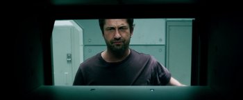 Movie still from “Geostorm” (2017), directed by Dean Devlin – A person looking at a mirror; Close Up shot, Low angle