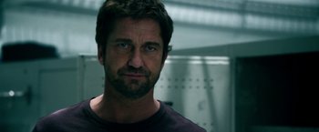 Movie still from “Geostorm” (2017), directed by Dean Devlin – A person with a beard; Close Up shot, Low angle