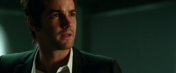 Movie still from “Geostorm” (2017), directed by Dean Devlin – A person wearing a suit and tie; Close Up shot, Over the shoulder angle