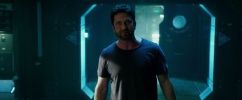 Movie still from “Geostorm” (2017), directed by Dean Devlin – A man standing in a dark room with his mouth wide open; Medium shot, Over the shoulder angle