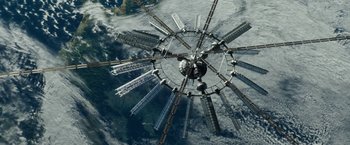 Movie still from “Geostorm” (2017), directed by Dean Devlin – An aerial view of a ferris wheel in the middle of the sky; Extreme Wide shot, Overhead angle