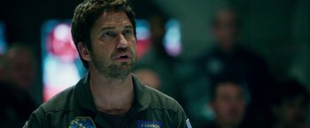 Movie still from “Geostorm” (2017), directed by Dean Devlin – A person wearing a uniform; Close Up shot, Over the shoulder angle