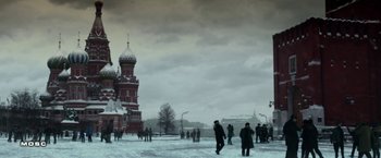 Movie still from “Geostorm” (2017), directed by Dean Devlin – A group of people standing in the snow near a building; Extreme Wide shot, Low angle