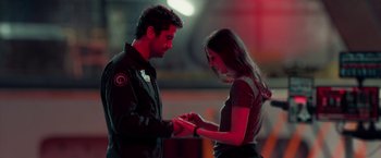 Movie still from “Geostorm” (2017), directed by Dean Devlin – A man and a woman holding hands in a dark room; Medium shot, Over the shoulder angle