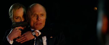 Movie still from “Geostorm” (2017), directed by Dean Devlin – An older man wearing a suit and tie; Close Up shot, Over the shoulder angle