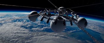 Movie still from “Geostorm” (2017), directed by Dean Devlin – An image of a space station above the earth; Extreme Wide shot, Overhead angle