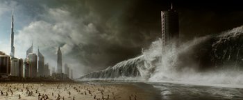 Movie still from “Geostorm” (2017), directed by Dean Devlin – A large wave crashing on a beach near a building; Extreme Wide shot, High angle
