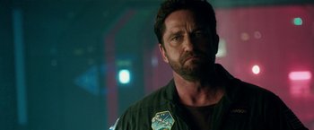 Movie still from “Geostorm” (2017), directed by Dean Devlin – Gerard butler in a scene from the movie olympus has fallen; Close Up shot, Over the shoulder angle