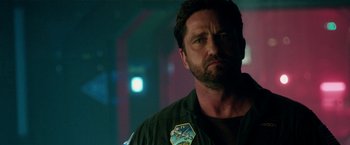 Movie still from “Geostorm” (2017), directed by Dean Devlin – Gerard butler in a scene from the movie olympus has fallen; Close Up shot, Over the shoulder angle